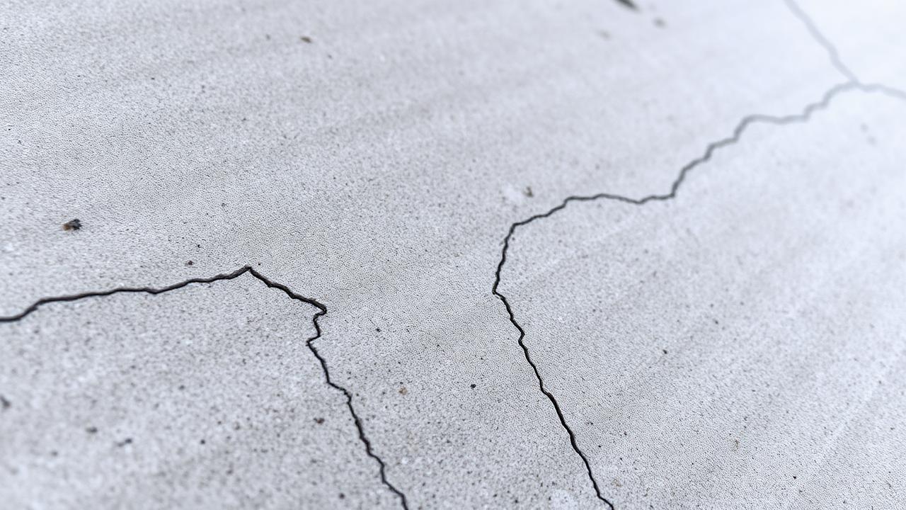 Close up of hairline shrinkage cracks on concrete surface